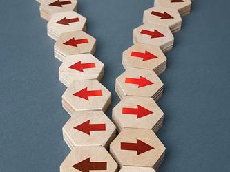 red arrows on wooden blocks going in opposite directions